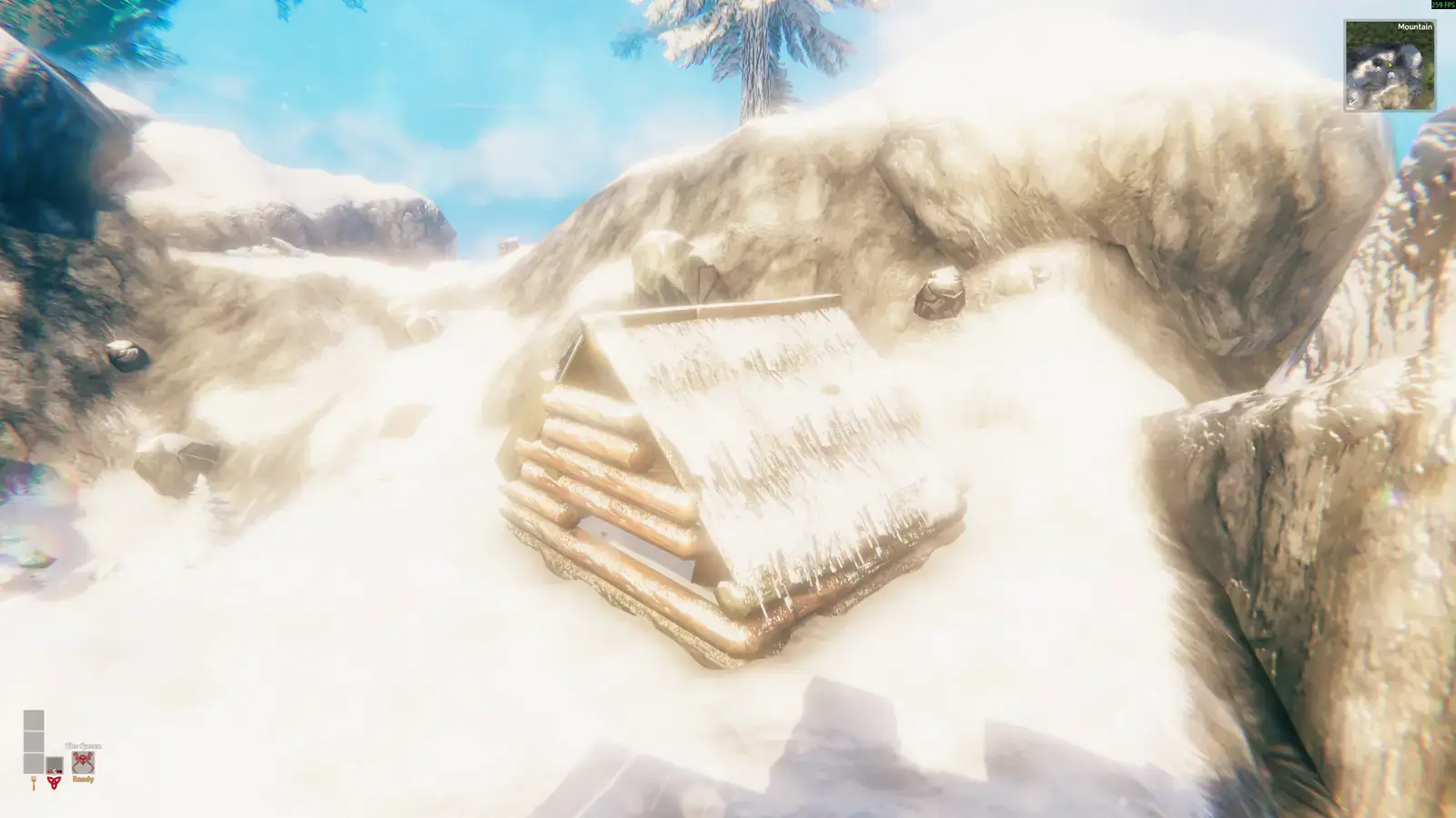 Tiny snow-covered mountain shack tucked into a bright snowy slope.